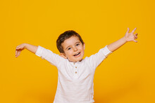 Excited Little Boy Raising Arms