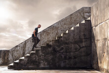 Man Climbing Concrete Stairs