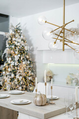 Wall Mural - Christmas decor. Bright interior of white kitchen with decorated Christmas tree, garlands and Christmas wreaths.