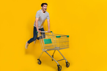 Poster - Full length photo of funky impressed man wear white t-shirt jumping high enjoying retail shopping isolated yellow color background