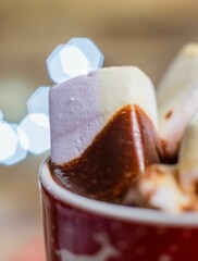 Wall Mural - Vertical closeup of the marshmallow in a cup of hot chocolate