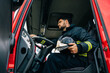 © ADDICTIVE STOCK - Male firefighter in fire engine