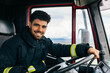 © ADDICTIVE STOCK - Cheerful Hispanic fireman driving fire engine
