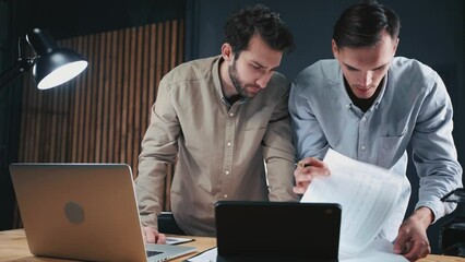 Wall Mural - young businessmen working in the office together at night .