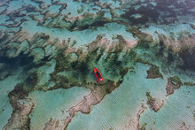 Aerial View Of A Red Boat Anchored Over Sand Banks, Kuta Mandalika Beach, Lombok, Nusa Tenggara, Indonesia