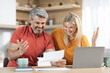 © Prostock-studio - Emotional attractive middle aged spouses reading correspondence at home