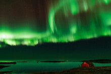Spectacular Aurora Dancing In The Skies Above A Red Boathouse In Mjelle.