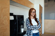 © BullRun - Content woman thinking near coffee machine