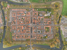 Fortified Historic City Center Of Elburg In The Netherlands, Gelderland, Medieval Fortress Almost Straight Street Plan. Former Fishing And Trading Town That Overlooked The Zuiderzee. Aerial.