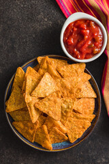 Wall Mural - Tortilla chips with the flavor of chili peppers on plate. Top view.