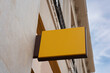 Mockup of yellow shop sign on wall