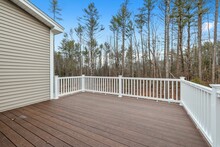 Decking Boards Of A Porch With White Railings In A Suburb House