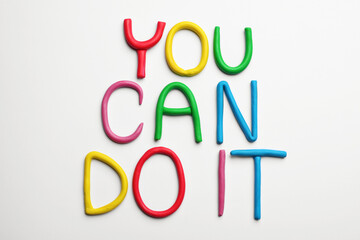 Wall Mural - Motivational phrase You Can Do IT made of colorful plasticine on white background, flat lay
