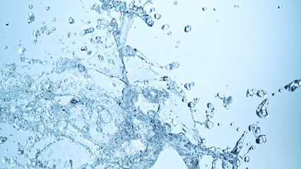 Poster - Water splash isolated on soft blue background.