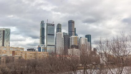 Wall Mural - Moscow City business center skyscrapers office buildings and luxury apartments timelapse hyperlapse. Ica on a river and towers winter panorama. Modern european architecture