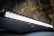 © Roman - Close up of custom LED light bar on roof rack off road car.
