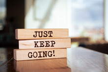 Wooden Blocks With Words 'Just Keep Going'.