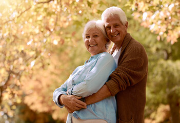 Wall Mural - Love, romance and old couple hug in garden, happy in retirement. Nature, summer and senior man and woman hugging. Marriage, loyalty and a smile, outdoor time for elderly people to relax on weekend.