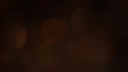 Wall Mural - Rainbow Bokeh Appearance and Disappearance. 4k Light Leaks footage. Abstract moving defocused background or overlay. Beautiful round multicolor bokeh fades against a dark background.