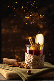 Fototapeta Dziecięca - Christmas drink. Mulled wine  decorated with apple and with spices on wooden cut board witj golden bokeh. Winter time beverage  concept.