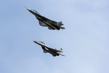 Formation flight by pair of fourth generation Su-35 (NATO - Flanker-E) and fifth generation Su-57 (NATO - Felon) aircraft. 100 years of the Russian Air Force. Zhukovsky, Russia, August 10, 2012