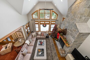 Sticker - High-angle shot of a modern living room with a fireplace. Custom-built house in the mountains.