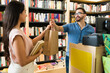 © AntonioDiaz - Hispanic woman customer paying for her books at the book shop