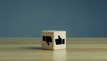 Wooden cube with Thumbs up down hands agree and disagree gesture, Like and dislike symbol, positive vs negative gesture