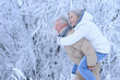 © aletia2011 - elderly man holding an old woman on his back in winter