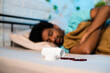 © WESTOCK - Young man in deep sleep with tablets or medicine pills on bed at night - conept of insomnia medication, unhealthy lifestyle and addiction