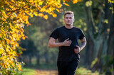 Runner in autumn park.