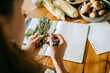 © Maskot - Hands of female food stylist doing quality check of rosemary herb at table