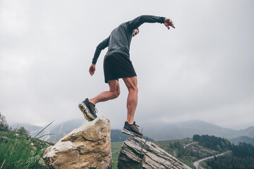 Wall Mural - Man running in the mountains