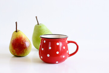 Wall Mural - A mug of pears juice. Juicy, tasty pears on the white background. Pear autumn harvest. Free space for text. Autumn nature concept.