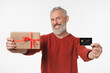 © InsideCreativeHouse - Smiling caucasian mature middle-aged man holding birthday Christmas present and credit card for online shopping e-banking e-commerce isolated in white background