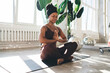 © BullRun - African American woman doing Anjali mudra in sunshine