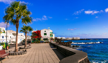 Wall Mural - Lanzarote scenic places. view of Punta Mujeres traditional fishing village with crystal sea and white houses. popular  for natural swim pools. Canary islands travel