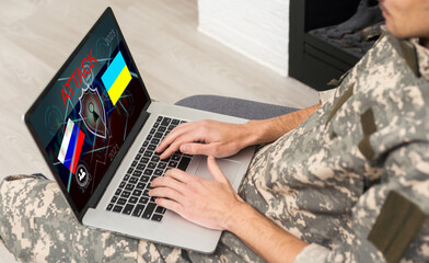 Surveillance and control of opposing information concept, Soldier in camouflage uniform working on laptop for Information Operation. Russia, Ukraine