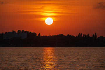 Wall Mural - The sun goes down over a lake