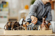 © Dusan Petkovic - Close up of a child playing with figurines of wild animals and learning trough the game.