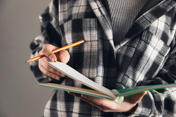 Canvas Print - Woman taking notes in a notebook