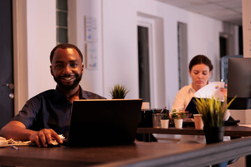 Poster - smiling employee working on laptop in coworking space portrait, corporate worker looking at camera a