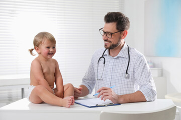 Wall Mural - Pediatrician examining cute little baby in clinic