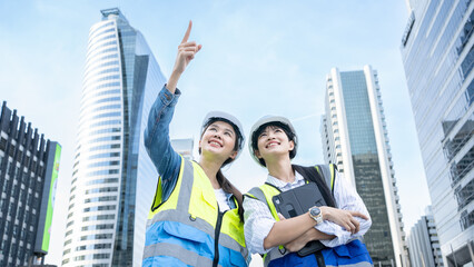 portrait of two professional asian engineer or technician workers stand look at camera with smiling 