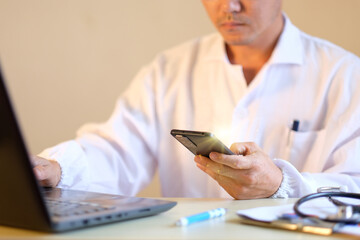 Poster - Doctor working in a clinic and using smartpone