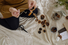 From Above View Of Unrecognizable Woman Creating Decorations Using Dried Lemon Slices