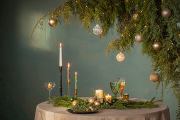 Wall Mural - green and golden christmas decor on table on dark background