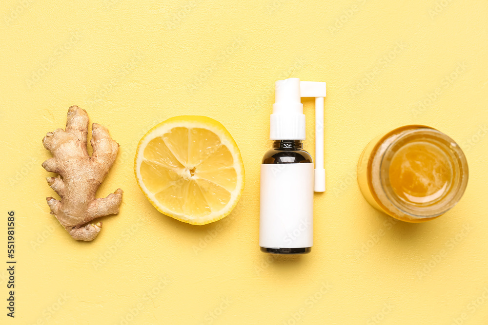 Spray for sore throat, ginger, lemon and honey on yellow background
