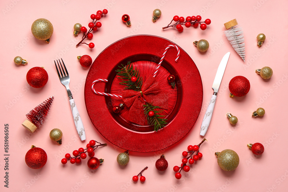 Table setting with Christmas decor on pink background