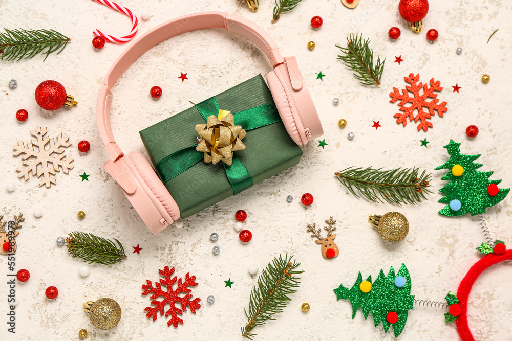 Headphones with gift and Christmas decor on grunge background